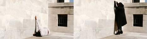 Across two images, a woman in black stands and crouches against a white marble exterior, caressing the surface.