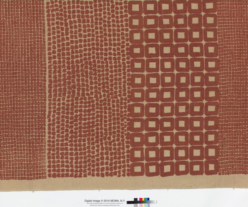 Red and cream textile sample featuring varied geometric patterns, including vertical dotted stripes and bordered squares.