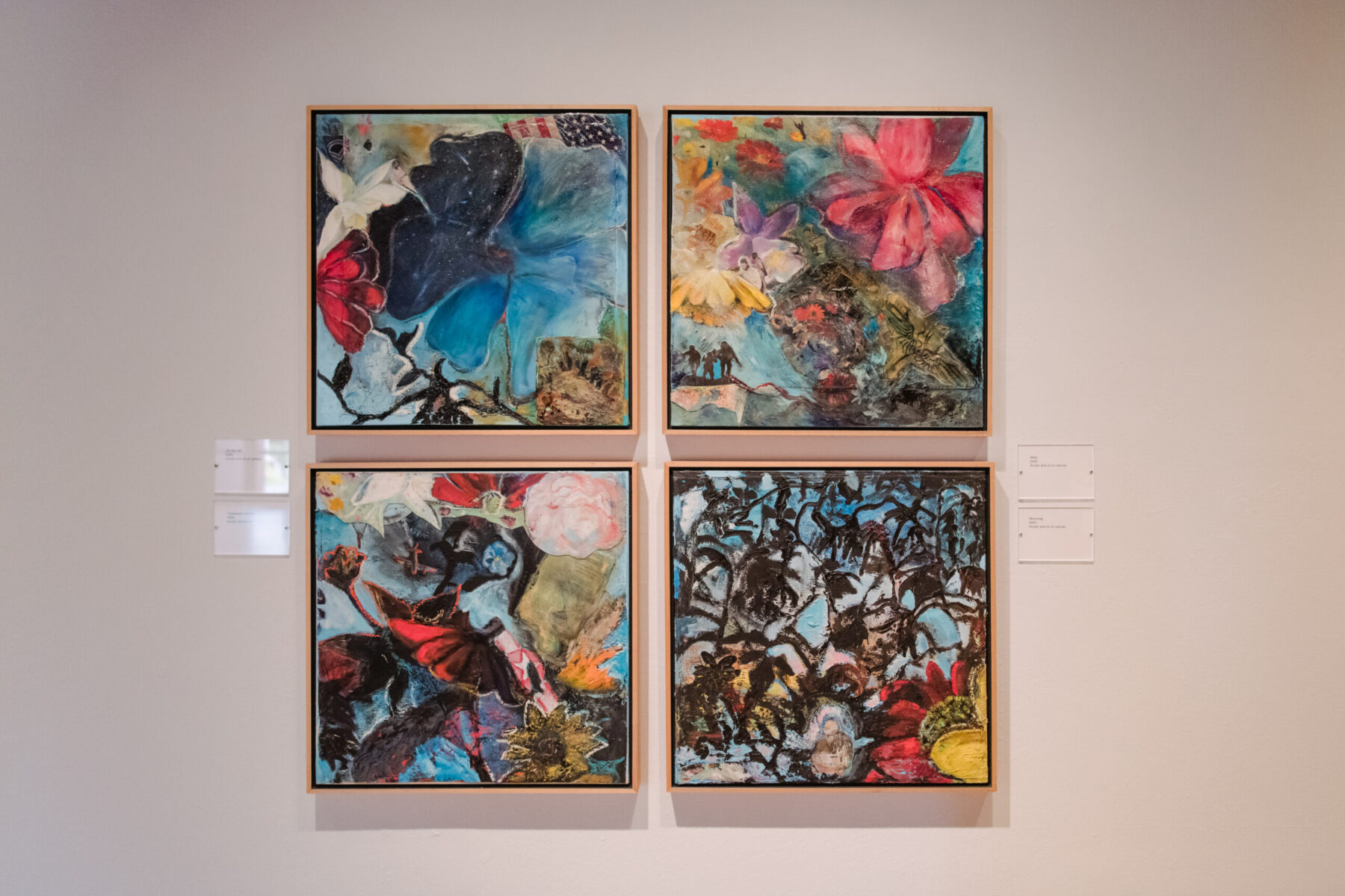 Installation view of Oletha DeVane: Spectrum of Light and Spirit. Four colorful square-shaped works of art hang side-by-side in a grid.
