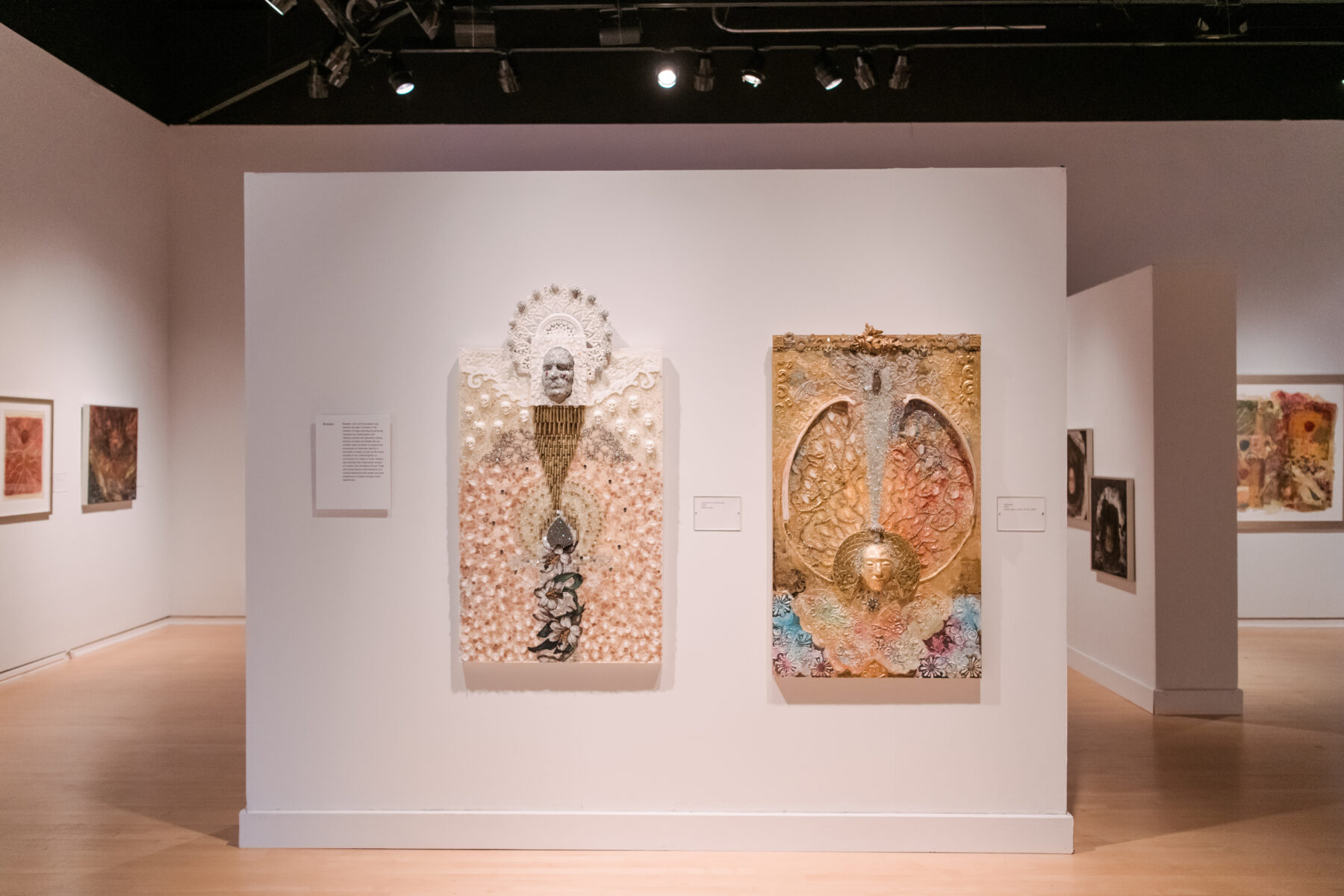 Installation view of Oletha DeVane: Spectrum of Light and Spirit. Two light-colored mixed-media works hang on the white gallery wall.