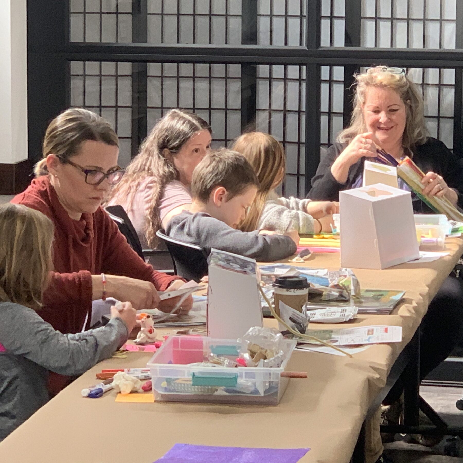 Families create miniature galleries in shadow boxes along a table of art supplies at the “Make Your Own Museum” Kids Club craft event at OCA Mocha.