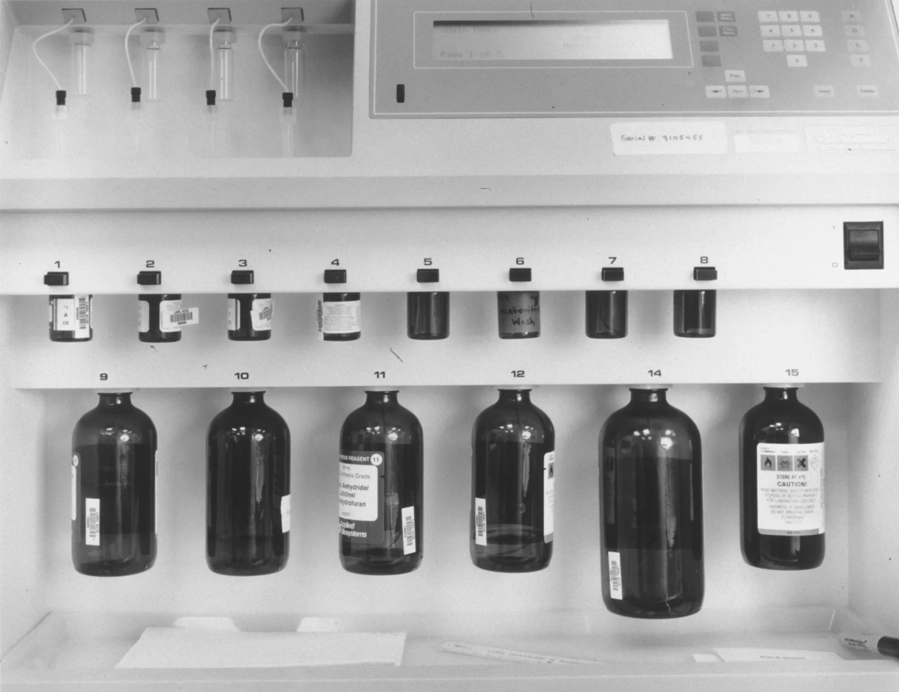 DNA/RNA Synthesizer by Catherine Wagner, 1995. A 20 by 24 inch black-and-white gelatin silver print depicting scientific equipment used for genetic synthesis. Courtesy of the artist, Anglim Gilbert Gallery, San Francisco, and Gallery Luisotti, Los Angeles.