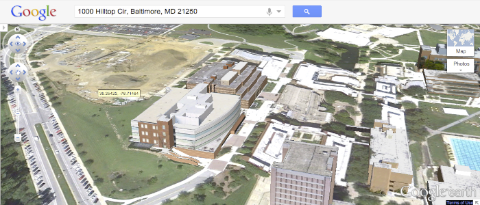 An aerial view of several of UMBC's campus buildings, streets, and green areas.